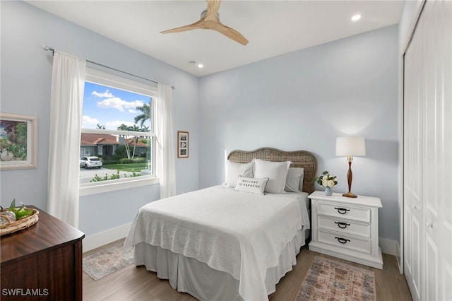 bedroom with baseboards, a ceiling fan, light wood-style floors, a closet, and recessed lighting