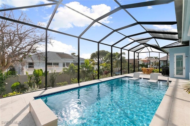 outdoor pool with a lanai and a patio