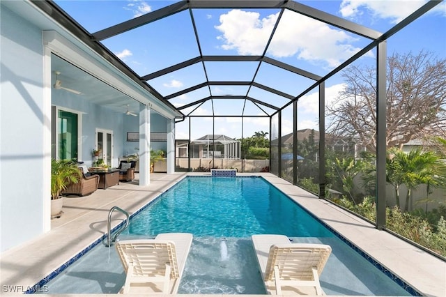 pool featuring a patio area, a lanai, and a ceiling fan