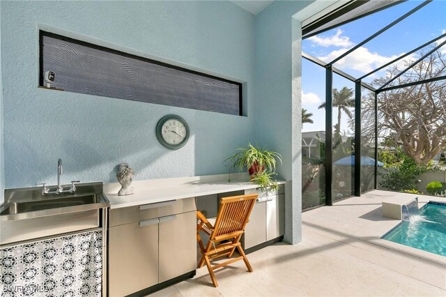 view of patio with a lanai, an outdoor pool, and a sink