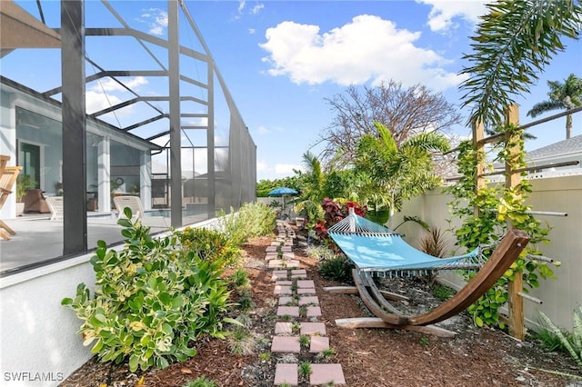 view of yard featuring a patio area and glass enclosure