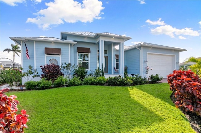 view of front of house featuring a garage, metal roof, a standing seam roof, and a front yard