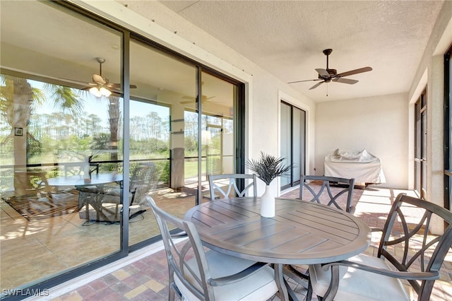 sunroom featuring ceiling fan