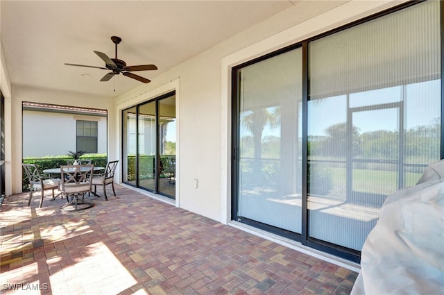 exterior space with outdoor dining area and ceiling fan