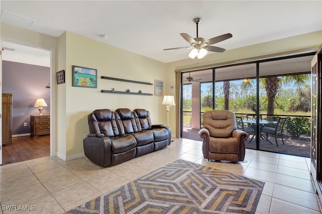 living room with light tile patterned flooring, baseboards, visible vents, and ceiling fan