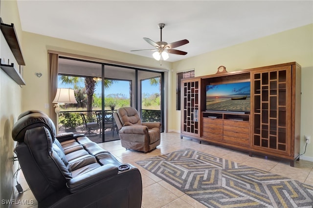 living room with baseboards, a ceiling fan, and tile patterned flooring