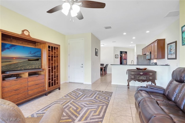 living room with light tile patterned floors, visible vents, baseboards, and recessed lighting