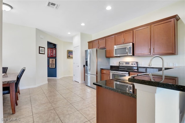 kitchen with light tile patterned floors, visible vents, a peninsula, recessed lighting, and stainless steel appliances