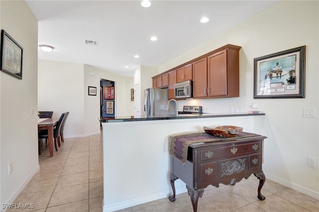 kitchen with visible vents, light tile patterned floors, brown cabinets, appliances with stainless steel finishes, and recessed lighting