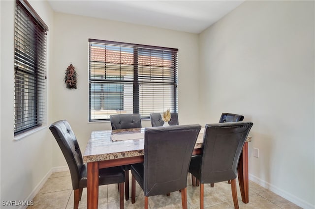 dining room featuring light tile patterned floors and baseboards