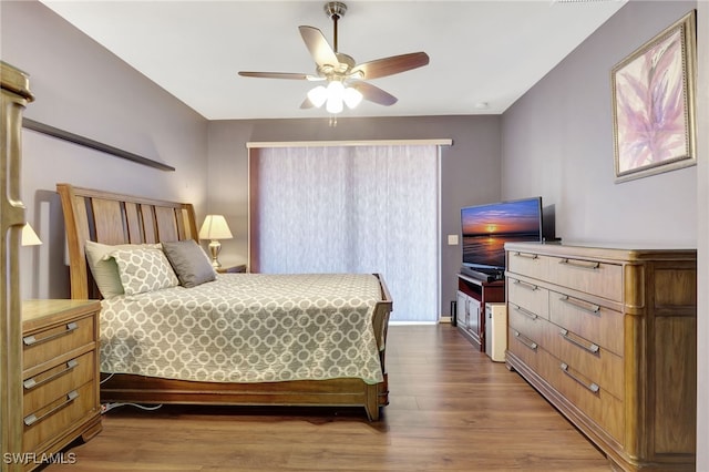 bedroom with a ceiling fan and dark wood-style flooring