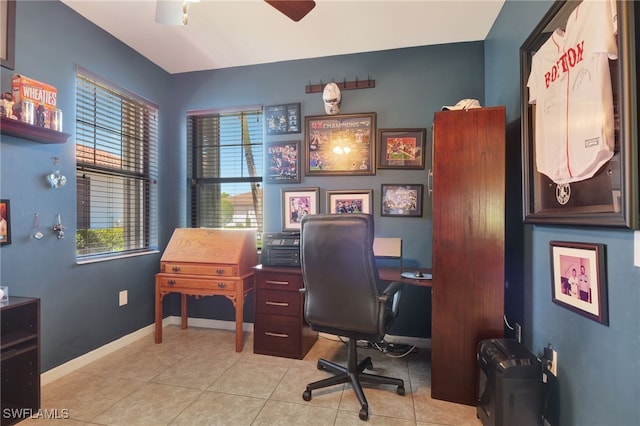 office featuring ceiling fan, baseboards, and light tile patterned flooring