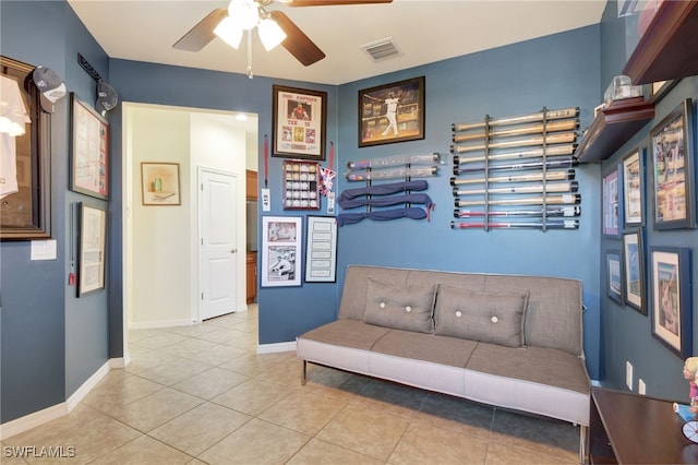 tiled living room with visible vents, baseboards, and ceiling fan