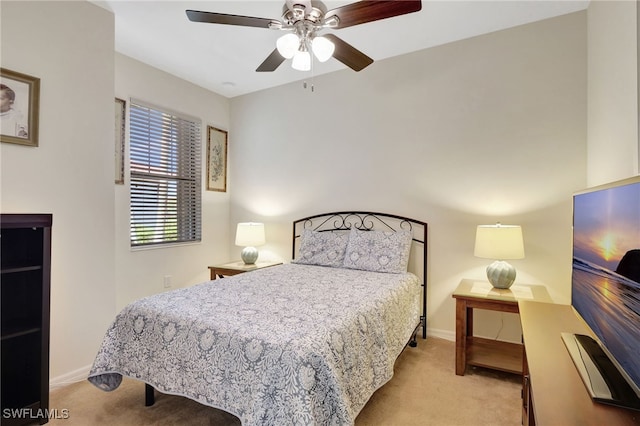 carpeted bedroom featuring ceiling fan and baseboards