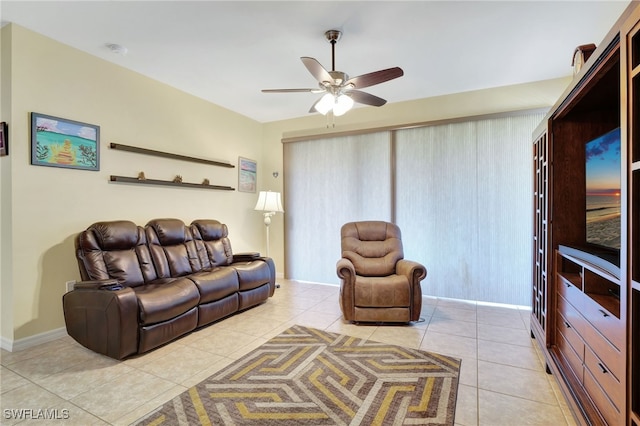 living area with light tile patterned flooring and a ceiling fan