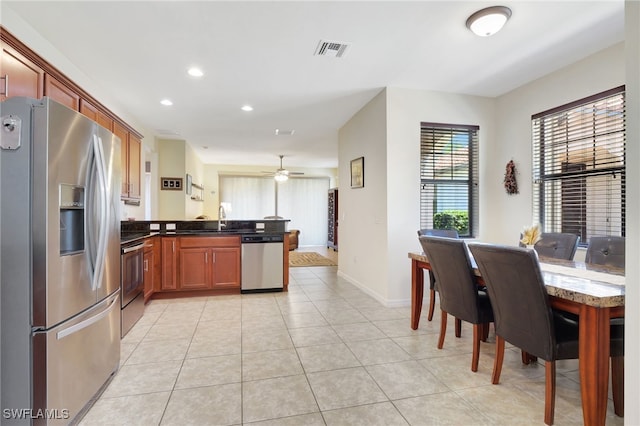 kitchen with visible vents, recessed lighting, a peninsula, light tile patterned flooring, and stainless steel appliances