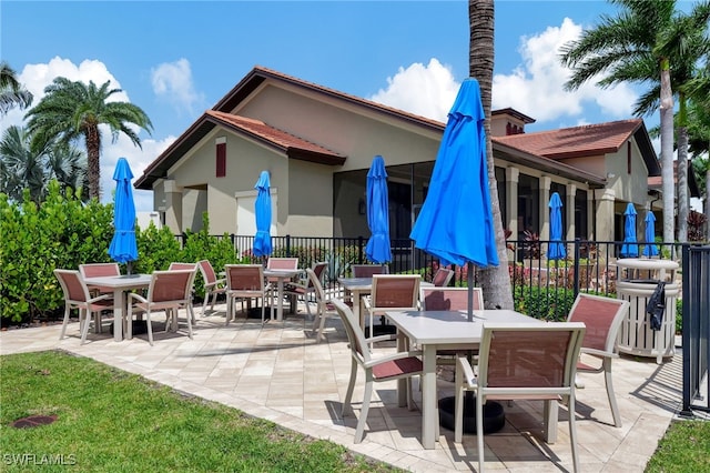 view of patio featuring outdoor dining area and fence