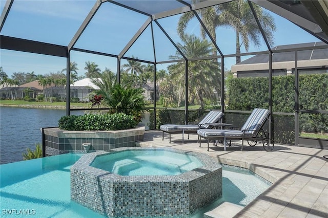 view of swimming pool featuring a pool with connected hot tub, a lanai, a water view, and a patio