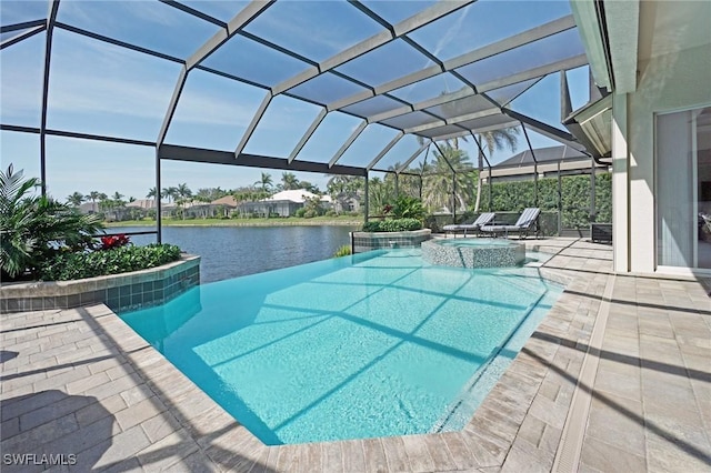 view of pool with glass enclosure, a patio, a water view, and a pool with connected hot tub