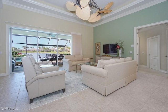 living area featuring baseboards, a ceiling fan, a sunroom, ornamental molding, and light tile patterned flooring