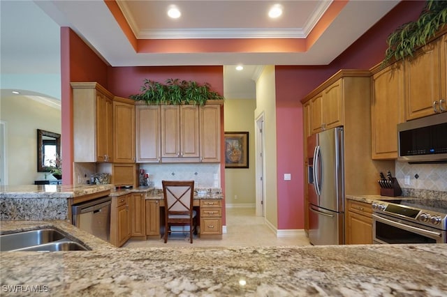 kitchen featuring a tray ceiling, appliances with stainless steel finishes, and crown molding