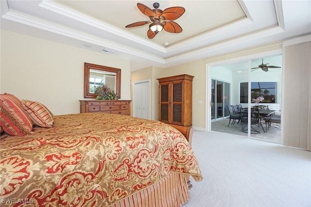 bedroom featuring access to outside, a raised ceiling, visible vents, and light colored carpet