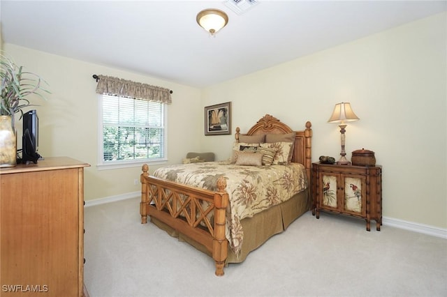 bedroom featuring baseboards, visible vents, and light colored carpet