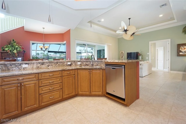 kitchen with dishwasher, a tray ceiling, a sink, and visible vents