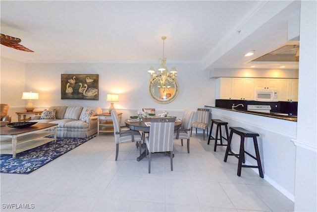 dining room featuring a chandelier, ornamental molding, and light tile patterned floors