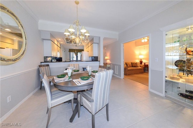 dining room featuring baseboards, ornamental molding, a notable chandelier, and light tile patterned flooring