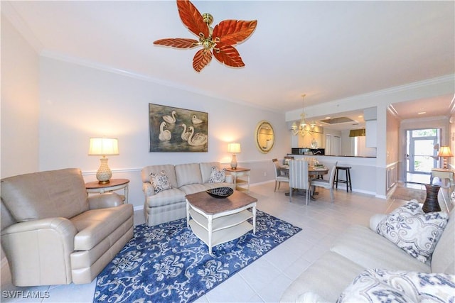 tiled living area featuring ornamental molding, baseboards, and a ceiling fan