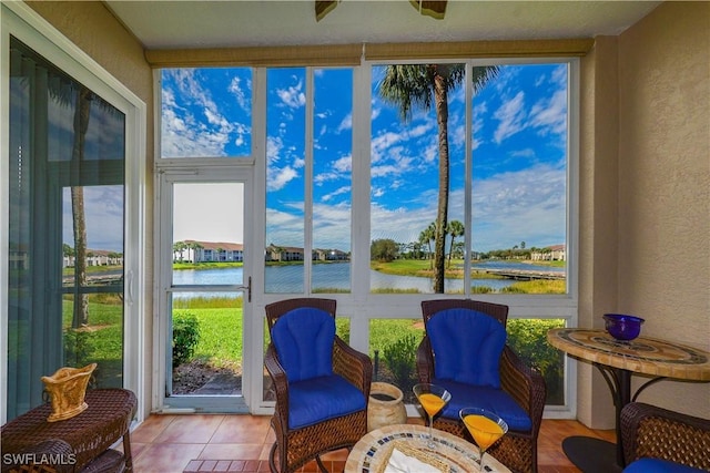 sunroom / solarium with a water view