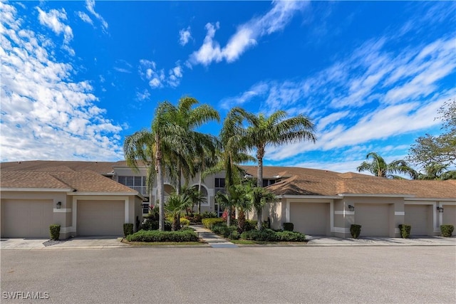 townhome / multi-family property with community garages and stucco siding