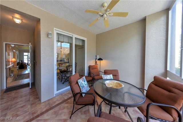 sunroom / solarium featuring ceiling fan