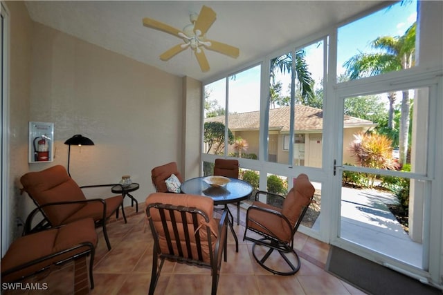 sunroom with a ceiling fan