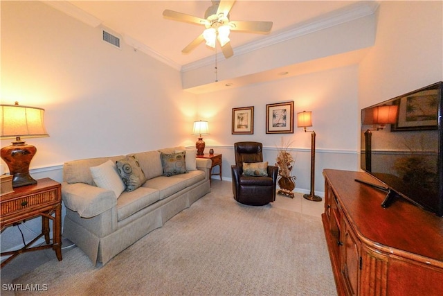 carpeted living room featuring ceiling fan, visible vents, and crown molding