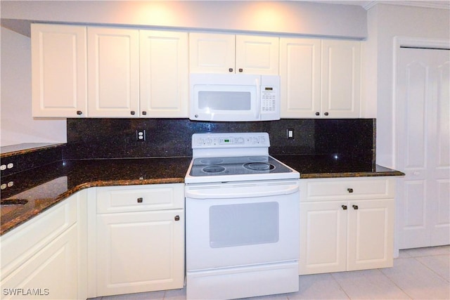 kitchen with white appliances, white cabinetry, backsplash, and light tile patterned floors