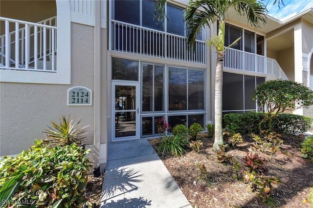 property entrance featuring stucco siding