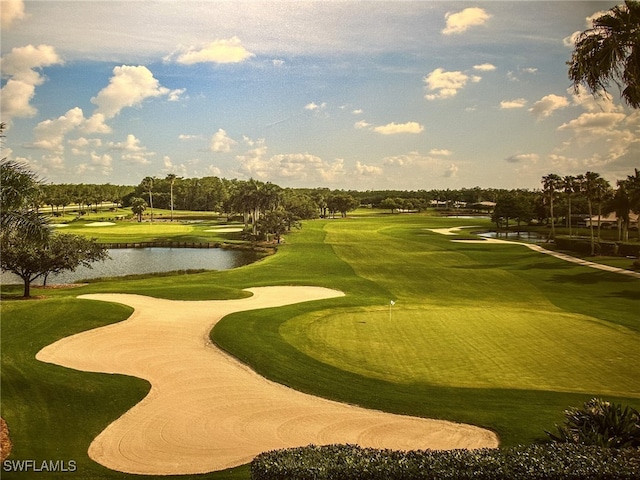 view of property's community with view of golf course and a water view