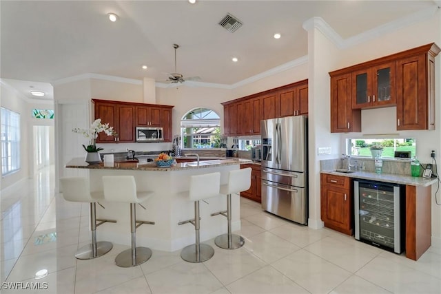 kitchen featuring light tile patterned floors, wine cooler, stone counters, stainless steel appliances, and glass insert cabinets