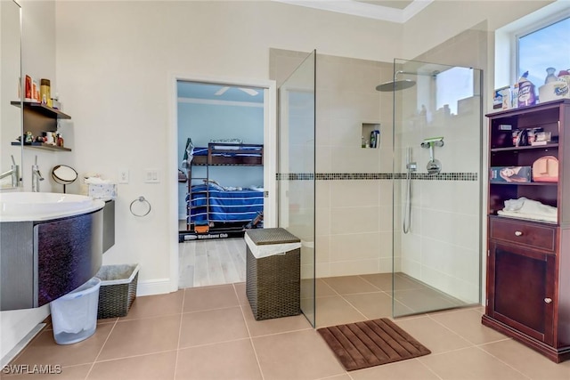 bathroom featuring tile patterned flooring, crown molding, and walk in shower