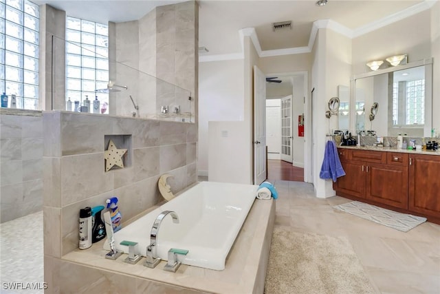 full bath featuring a garden tub, tile patterned flooring, vanity, visible vents, and ornamental molding