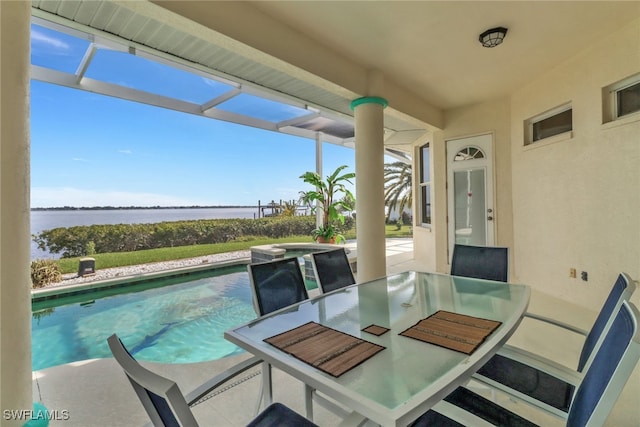 exterior space with a water view, a pool with connected hot tub, and outdoor dining area