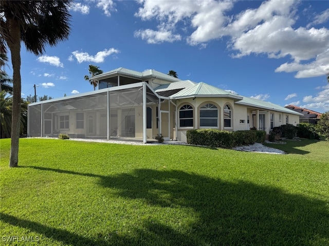 rear view of house featuring a yard and a lanai