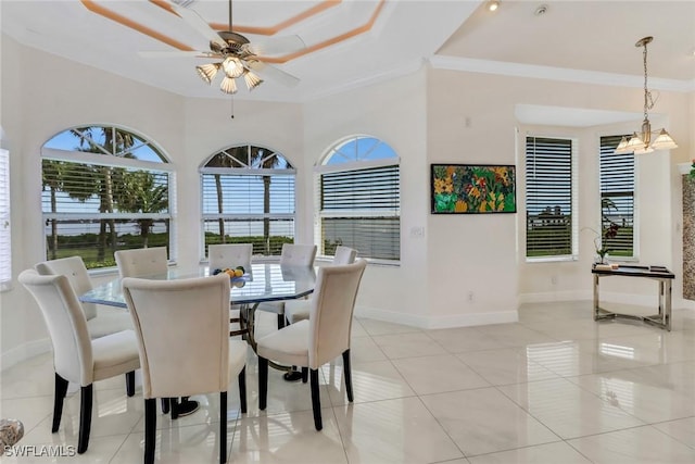 dining room with plenty of natural light, light tile patterned flooring, crown molding, and baseboards