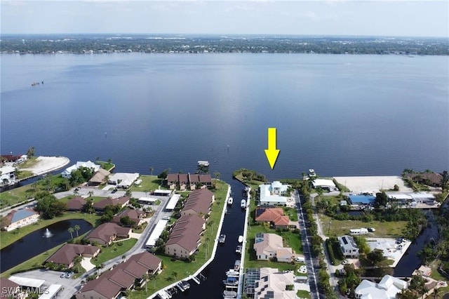 birds eye view of property with a water view and a residential view