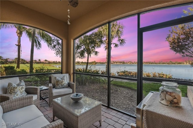 sunroom with a water view and plenty of natural light