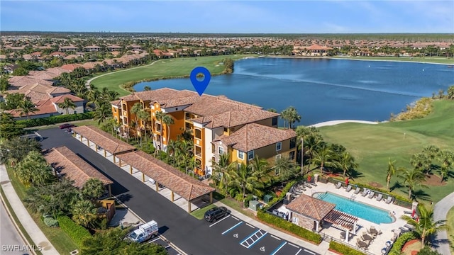 bird's eye view featuring view of golf course and a water view