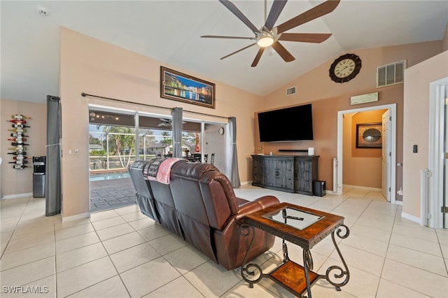 living area featuring a ceiling fan, visible vents, vaulted ceiling, and light tile patterned floors