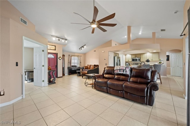 living area featuring rail lighting, visible vents, a ceiling fan, light tile patterned flooring, and vaulted ceiling